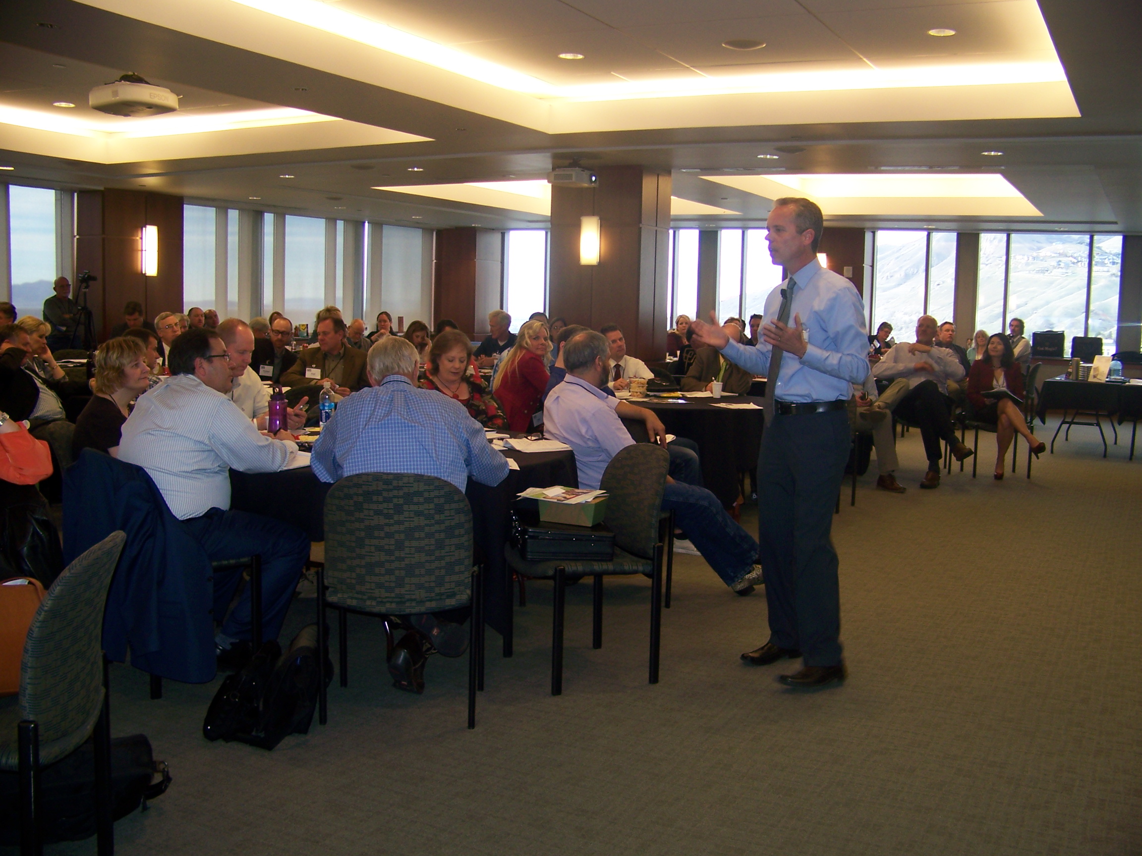 Martin speaking with attendees at a seated event