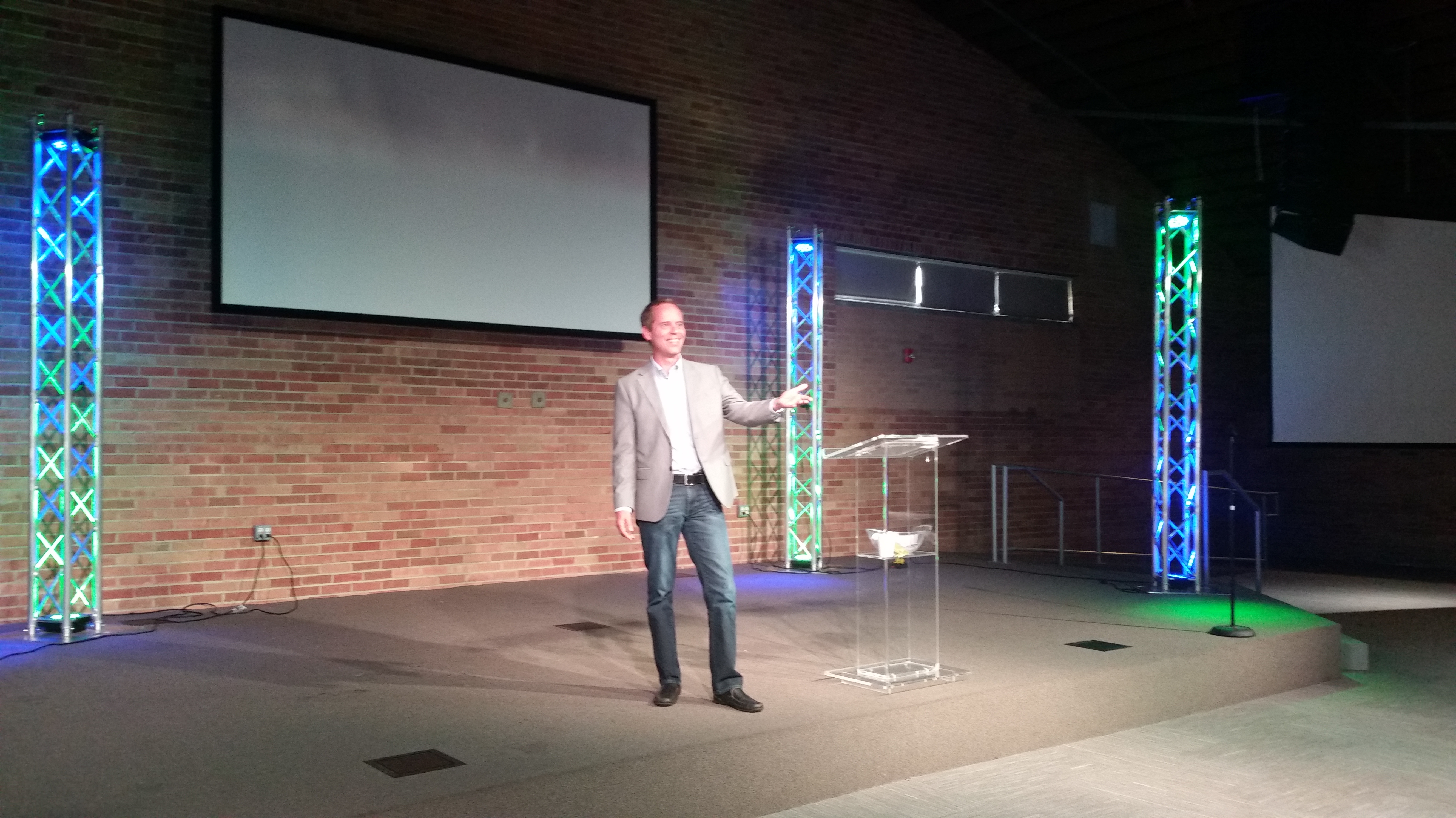 Martin presenting on stage beside a lectern